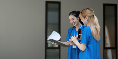 Nurses laughing and reviewing notes during a break