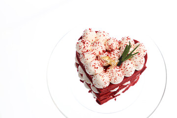 Close-up cake, cream cheese frosting,and raspberries red velvet cake on a white table.