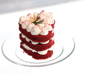 Close-up cake, cream cheese frosting,and raspberries red velvet cake on a white table.