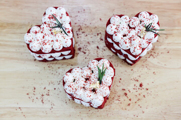 Close-up cake, cream cheese frosting,and raspberries red velvet cake on a white table.