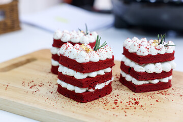 Close-up cake, cream cheese frosting,and raspberries red velvet cake on a white table.