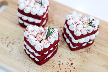 Close-up cake, cream cheese frosting,and raspberries red velvet cake on a white table.