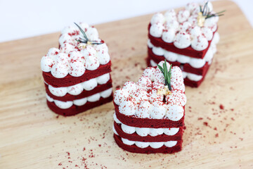 Close-up cake, cream cheese frosting,and raspberries red velvet cake on a white table.