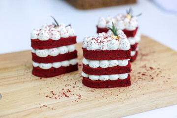 Close-up cake, cream cheese frosting,and raspberries red velvet cake on a white table.