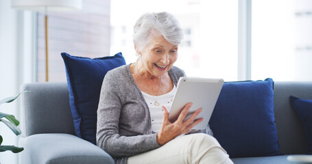 Video call, contact and senior woman with tablet on sofa in living room for telehealth communication. Happy, good news and elderly person on virtual medical consultation on digital technology in home