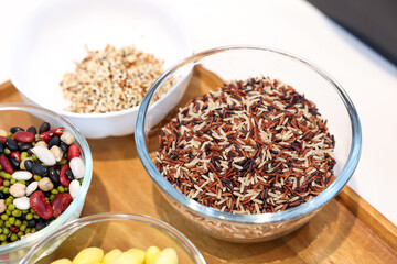 Different types of cereals, seeds and legumes on wooden table, flat lay