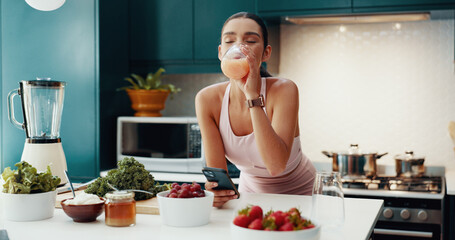 Phone, kitchen and woman drinking smoothie in home for gut health, wellness and liquid breakfast....