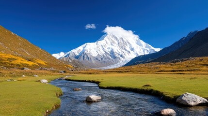 Majestic snow-capped peaks rise above a tranquil valley river