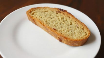 Slice of freshly baked bread on a white plate, freshly sliced bread, fresh bread, inviting snack