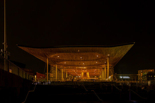 Senedd building illuminating Cardiff city center at night
