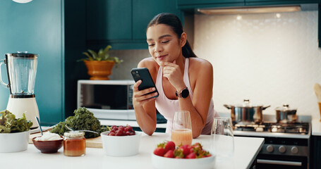 Phone, reading and woman with smoothie in kitchen for health, wellness and diet breakfast. Recipe,...