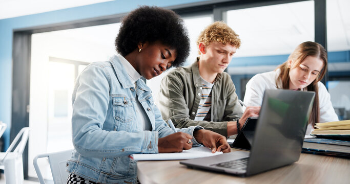 Education, group and students with laptop, classroom and research for assignment in college or writing. University, learning and people with tech for knowledge, studying and teamwork for project