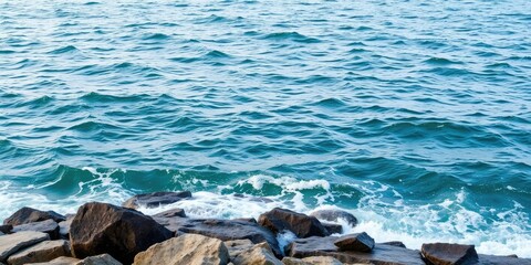 Fototapeta premium Rough seas in the background as gentle waves lap at a rocky shoreline, coastline, turbulent sea, ocean