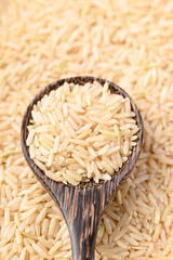 Organic Jasmine brown rice seed in wooden spoon, Thai Rice