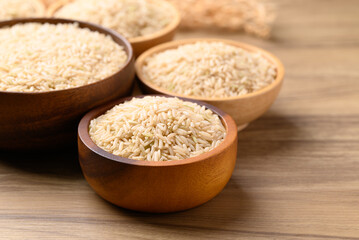Organic Jasmine brown rice seed in wooden bowl, Thai Rice, Food ingredient