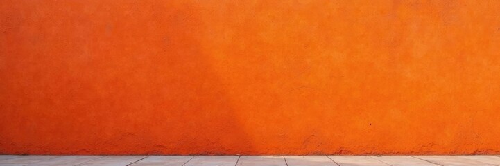 The facade wall is painted a deep, burnt orange, with subtle texture visible in the background, earthy, wall