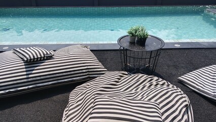 Black and white patterned seat by the pool