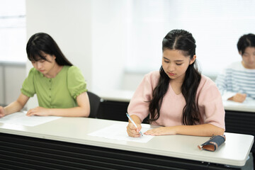 授業料のクラスで勉強するアジアのティーンエイジャー