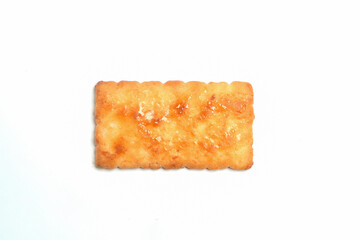 Square biscuit isolated on white background. Sweet and crunchy taste.Snack food industry concept.Copy space for text.For graphic design or banner background