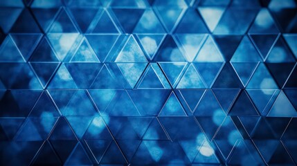 Background with blue triangles arranged in a diamond pattern with a bokeh effect and color grading