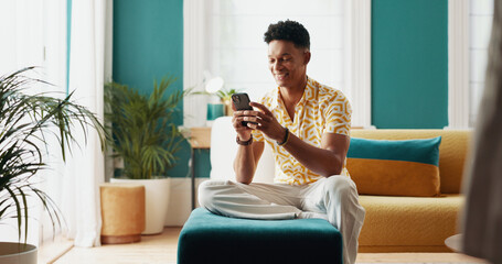 Happy, man and student with phone at home of education results, university application and...