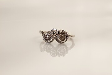 Elegant handmade silver ring with raw gemstones on a white background for stylish women.