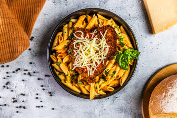 Crispy breaded chicken served over penne pasta tossed in a spicy arrabbiata sauce, topped with fresh basil and shredded mozzarella cheese.