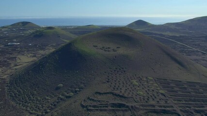 Aerial drone view of mountain sea and volcanoes in Lanzarote, Canary Islands, Spain