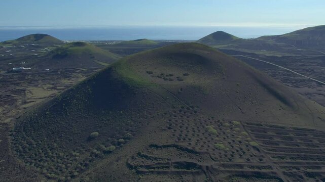 Aerial drone view of mountain sea and volcanoes in Lanzarote, Canary Islands, Spain