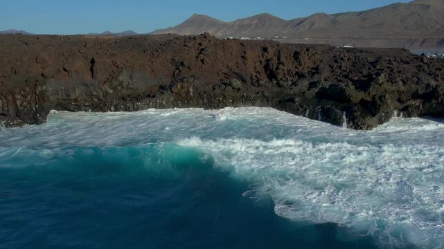 Aerial drone view of mountain sea and volcanoes in Lanzarote, Canary Islands, Spain