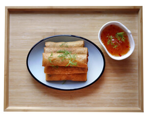Deep fried spring roll in golden brown color, served in a blue oval shape plate, famous local street food in Thailand, food industry concept