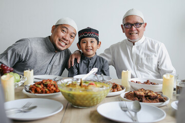 Portrait Of Multi Generation Muslim Family Smiling At Camera Celebrating Eid Mubarak