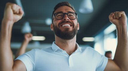 Triumphant Moment: A close-up portrait of a jubilant businessman with a beard, radiating pure joy and success as he celebrates a significant achievement in the workplace.