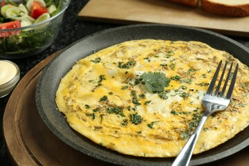Tasty brunch. Delicious omelette and salad served on table, closeup