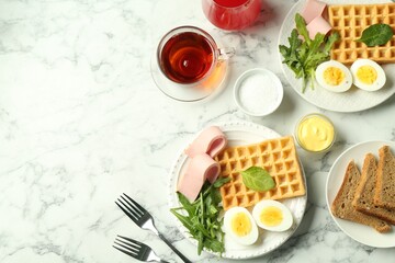 Flat lay composition with tasty brunch served on white marble table. Space for text