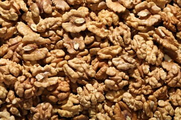 Pile of fresh ripe walnuts as background, top view