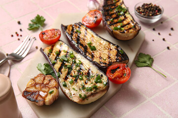 Delicious grilled eggplants, tomatoes and spices on light background
