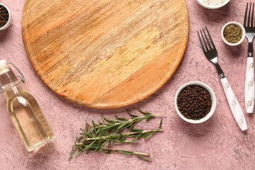 Composition with wooden cutting board and fresh spices on color background