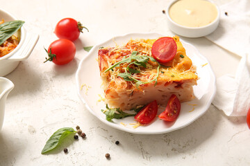 Plate of pasta with tomato sauce and cheese on grey background