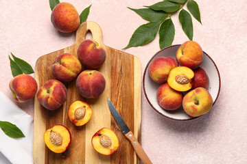 Board and bowl with sweet peaches on pink background
