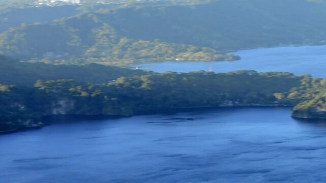 A captivating video of Lake Ilopango, El Salvador, highlighting its volcanic crater, tranquil waters, and vibrant daytime scenery.
