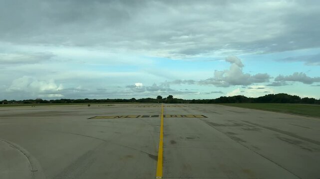 An immersive FPV perspective through the pilot&rsquo;s eyes recorded from a jet cockpit reaching the Runway 19 ready for takeoff under a clouded sky. 4K 60FPS