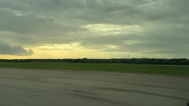 An immersive pilot&rsquo;s FPV perspective recorded from an airplane cockpit aligning into thre ruway ready for takeoff at sunset under a clouded sky 4K 60FPS