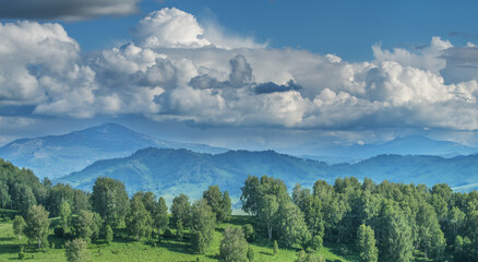 Spring view, green meadows and hills, cloudy day
