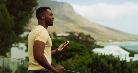 Phone, thinking and vacation with black man outdoor in nature for scenic holiday or travel to coast. Adventure, explore and view with happy influencer person in mountain location for tourism review