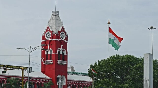 Chennai Central with clock, tree and two indian flags at periamet, kannappar thidal, chennai, tamil nadu, india. day time, stable shot, 4k.