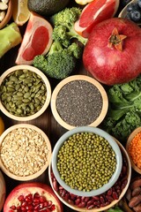 Different superfood products on wooden table, flat lay