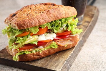 Delicious baguette sandwich with tomatoes and yellow beans on grey textured table, closeup