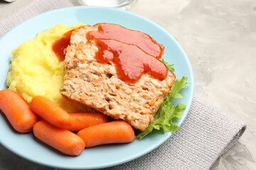 Delicious baked turkey meatloaf with mashed potato served on grey table, closeup