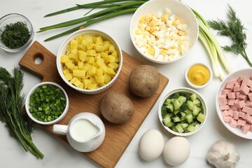 Ingredients for okroshka soup on white table, flat lay